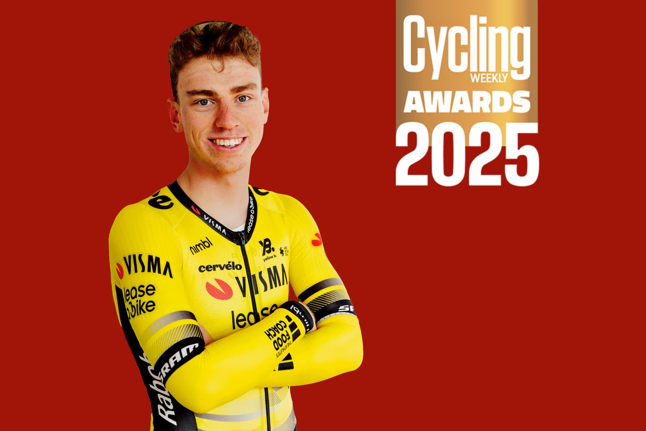 Matthew Brennan stood against a red background