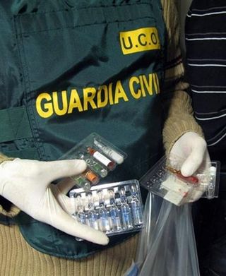 Spanish Guardia Cival holding drugs after dismanteling an alleged doping network in Valencia, November 24, 2009
