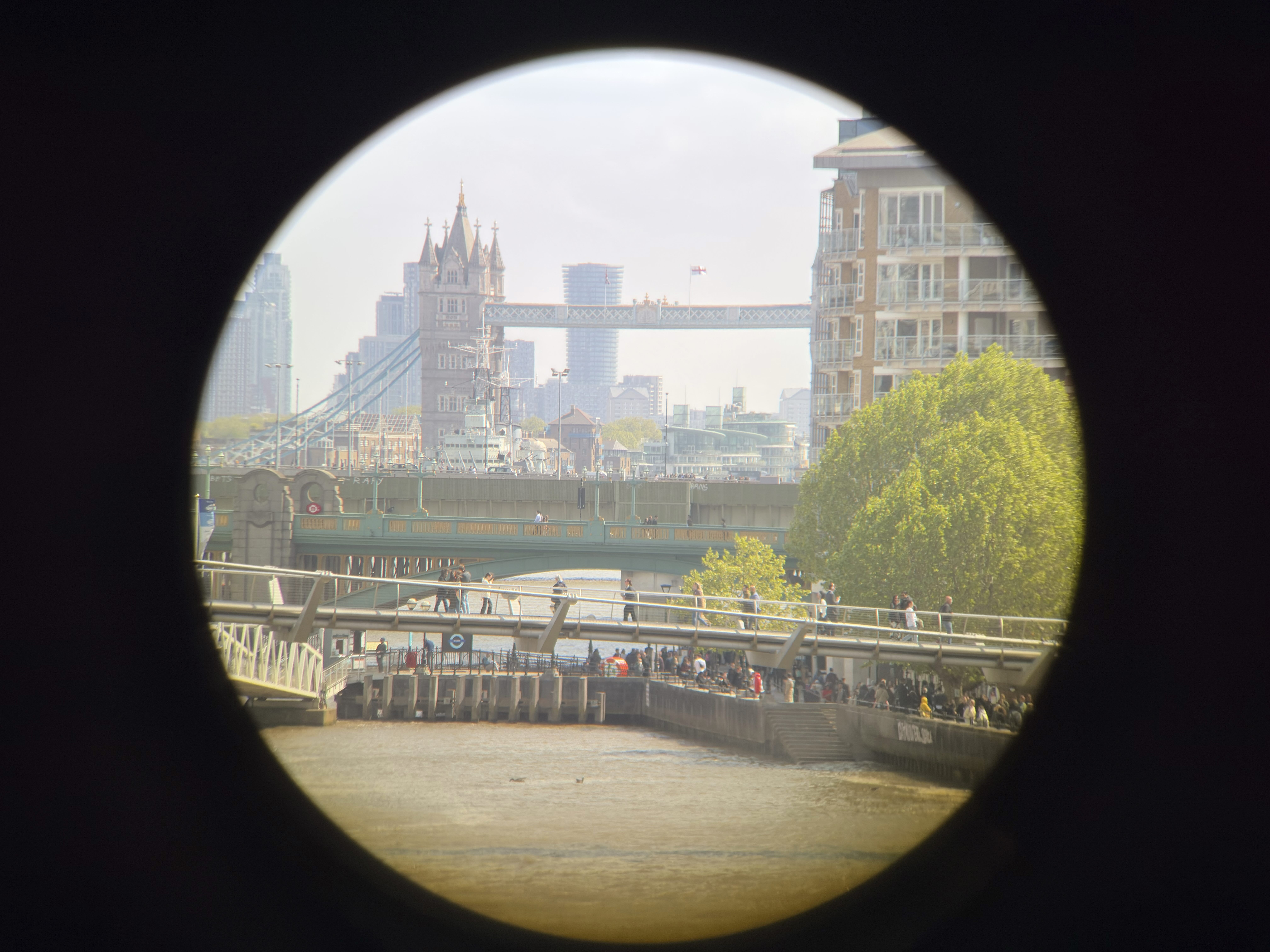 A circular black vignette framing a shot of fridges over the Thames