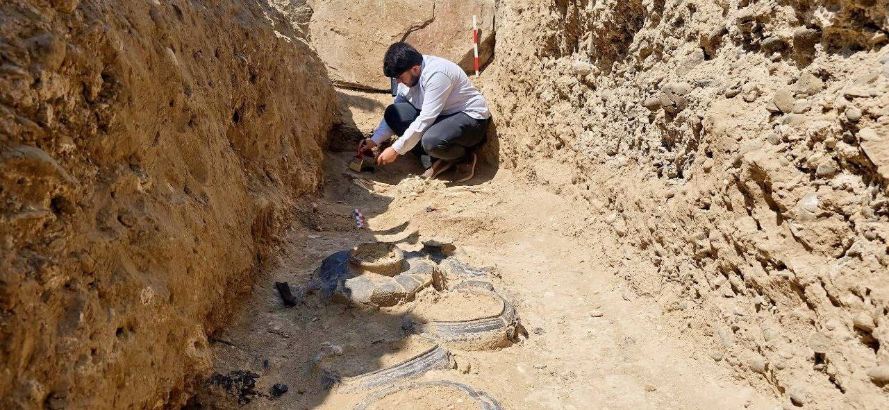 an archaeologist excavates a grave
