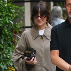 Dakota Johnson wearing a trench coat in NYC