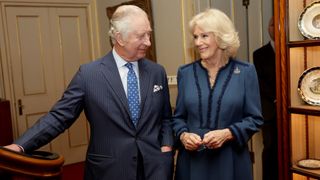 King Charles III and Camilla, Queen Consort laugh during a reception to celebrate the second anniversary of The Reading Room at Clarence House on February 23, 2023