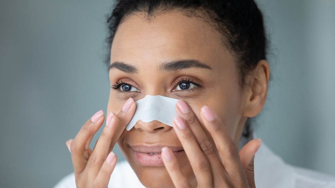 woman applying a pore strip