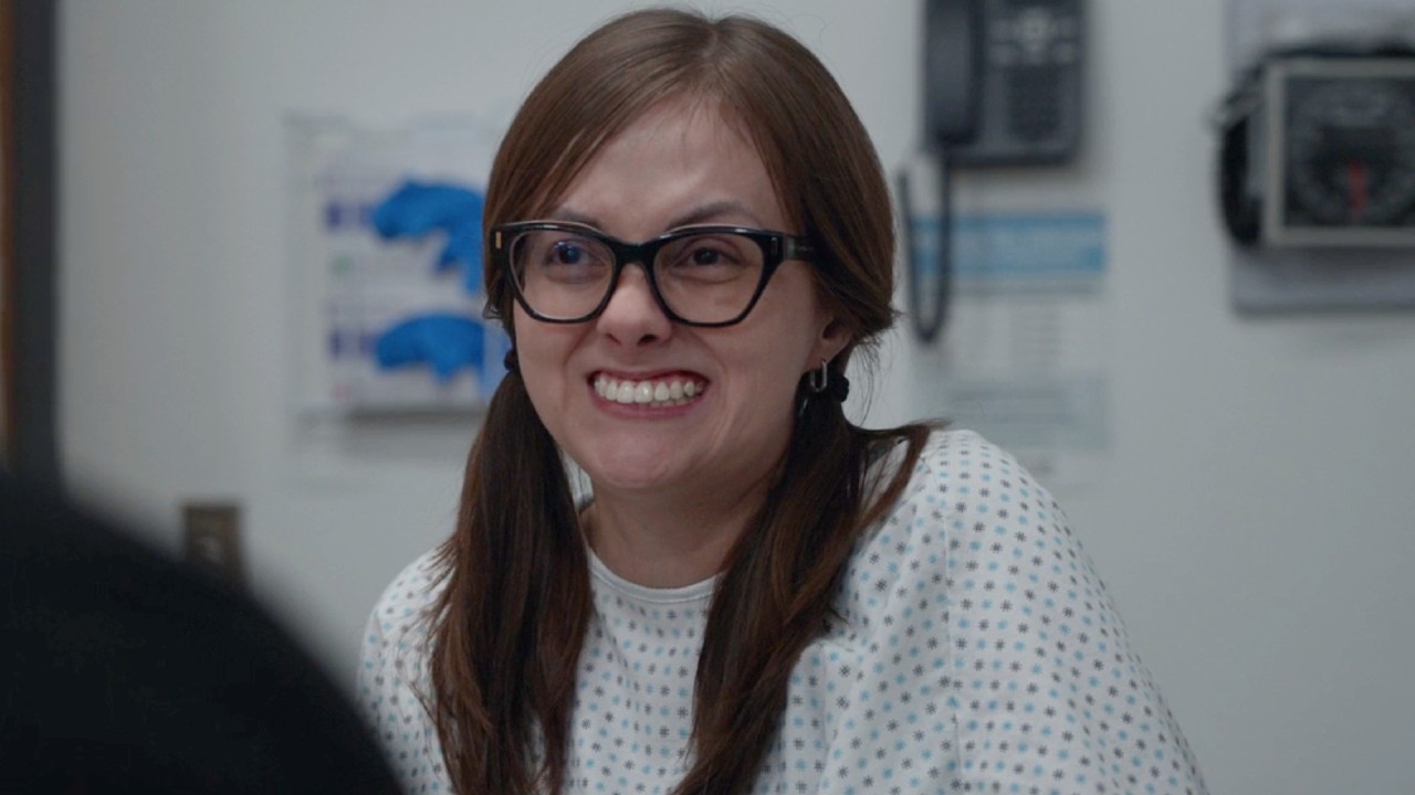 Tal Anderson smiling as Becca on The Pitt. 