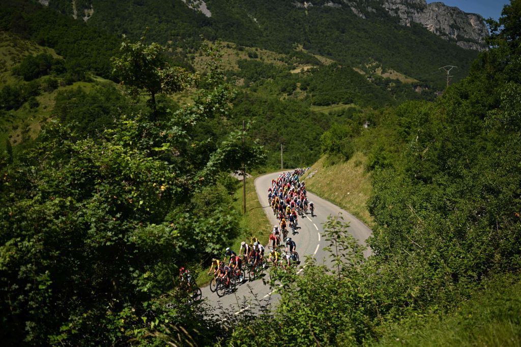 The pack ridesduring the sixth stage of the 74th edition of the Criterium du Dauphine cycling race 1965 km between Rives and Gap central eastern France on June 10 2022 Photo by Marco BERTORELLO AFP Photo by MARCO BERTORELLOAFP via Getty Images