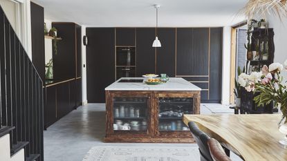 black kitchen with vintage style island and fluted glass fronts