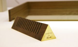 Part of a collection of desk accessories called 'Geometrics', this smart walnut and brushed brass envelope holder by Birmingham-based studio Plant & Moss features subtle laser etched markings reminiscent of school geometry sets