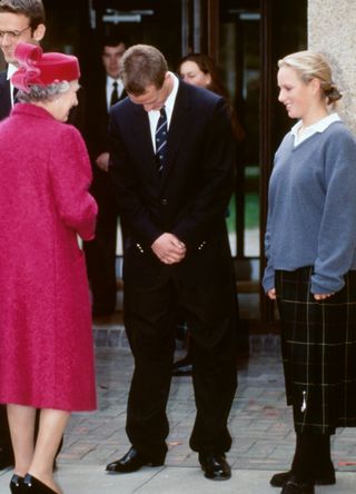 Queen Elizabeth II meets Peter and Zara Phillips at their school in 1990