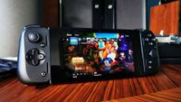 Razer Edge handheld with PS5 main menu on screen with Crash Bandicoot N-Sane Trilogy selected