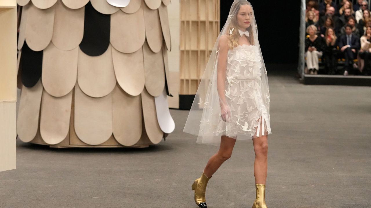 Model wears a mini wedding dress at the Chanel Haute Couture Spring Summer 2023 runway show