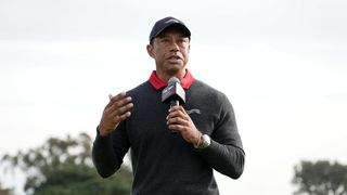 Tiger Woods speaks into a microphone during the 2025 Genesis Invitational trophy ceremony