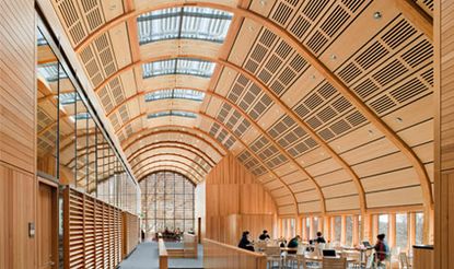 Interior featuring a long, curved ceiling out of wood and glass