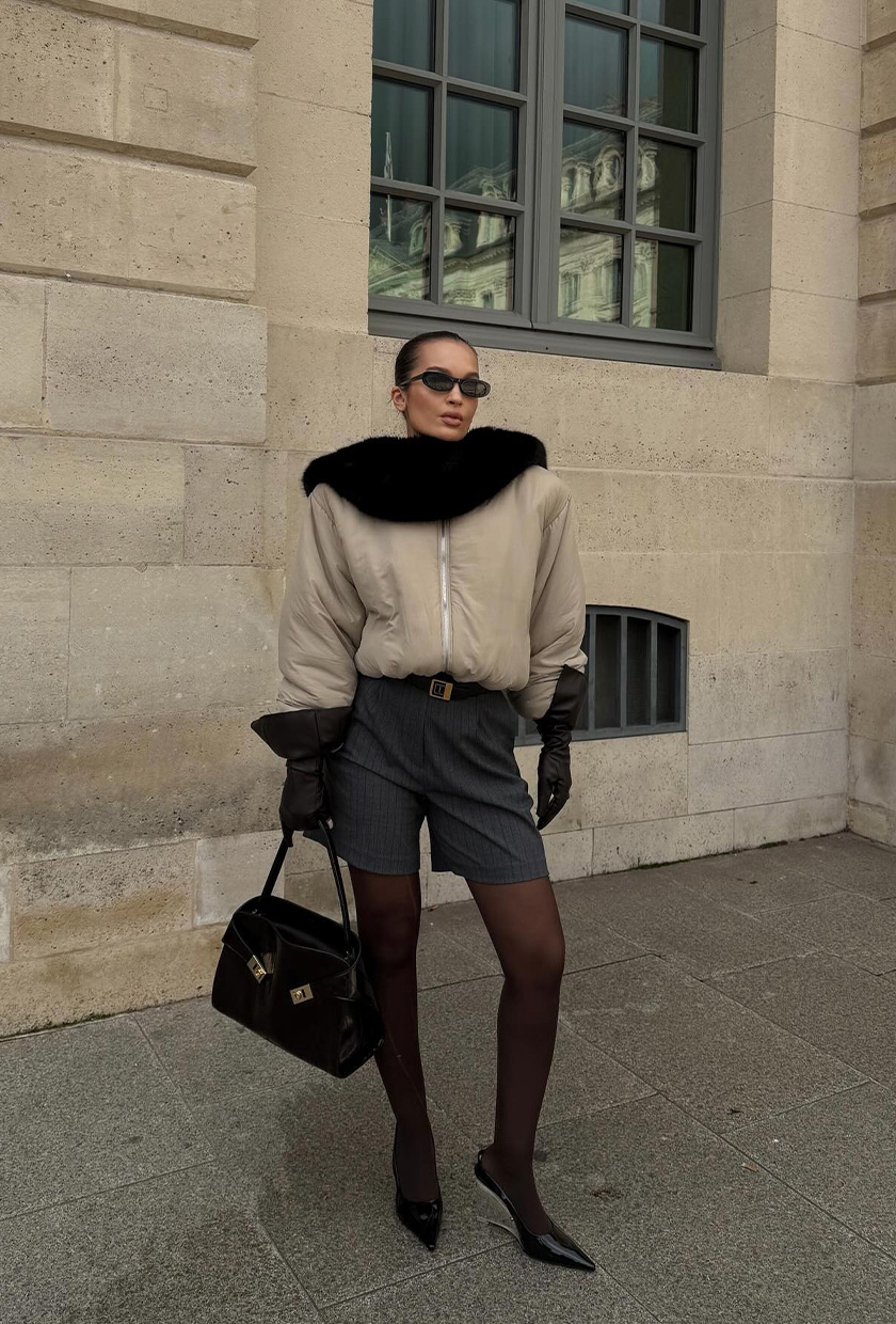 Fur accessory trend is shown in a street style photo of a woman