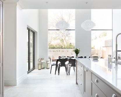 open plan white kitchen with big windows - increase the value of your home