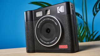 A black Kodak Mini Shot 4 Era 2-in-1 instant camera and printer