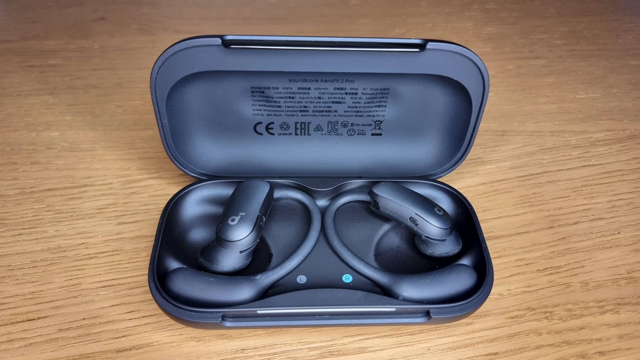 A picture of the Soundcore Aerofit 2 Pro earbuds sitting in an open charging case