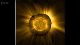 An image of the orange disk of the sun surrounded in a bast, glowing ring of spikes called the corona