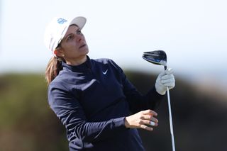 Mia Hamm watches her tee shot after hitting a driver