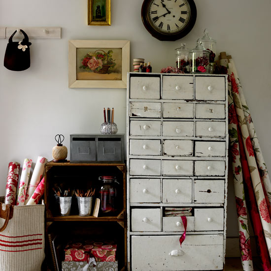 white room with drawer and wall clock