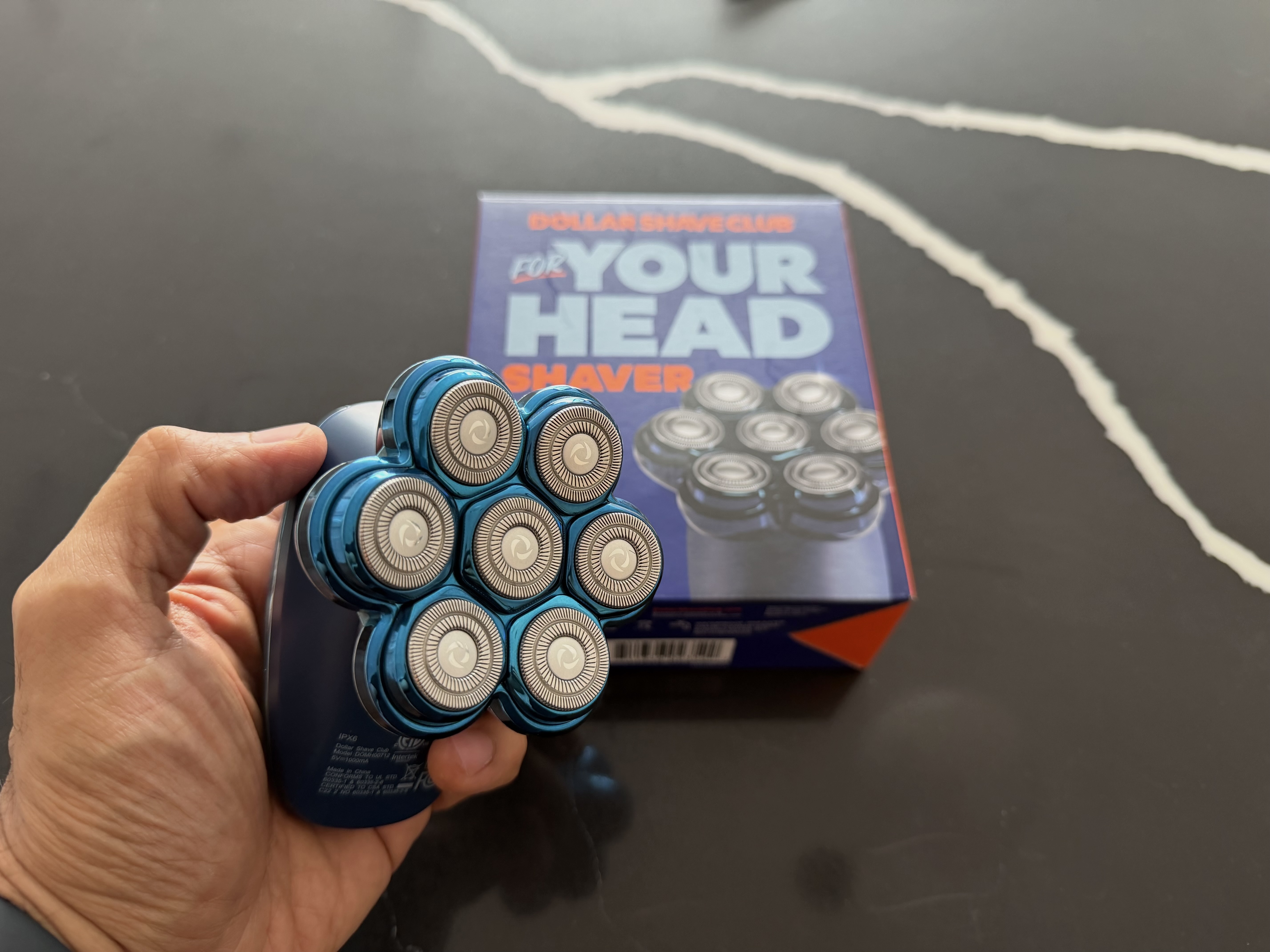 Dollar Shave Club Head Shaver held in hand