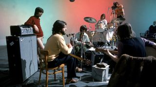 The Beatles rehearsing together at their instruments in The Beatles: Let It Be