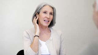 Woman with tinnitus holding ear