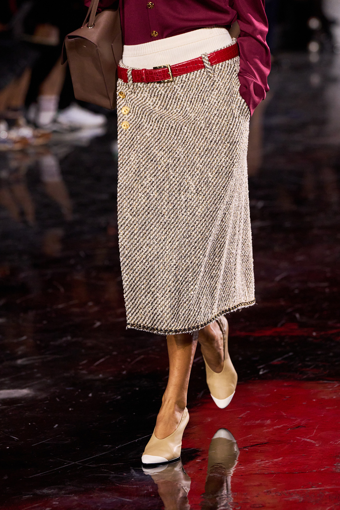 A model at the spring/summer 2026 show for Chanel wearing shrunken cap-toe heels.