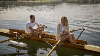 Press image of Elizabeth and Calvin rowing together.