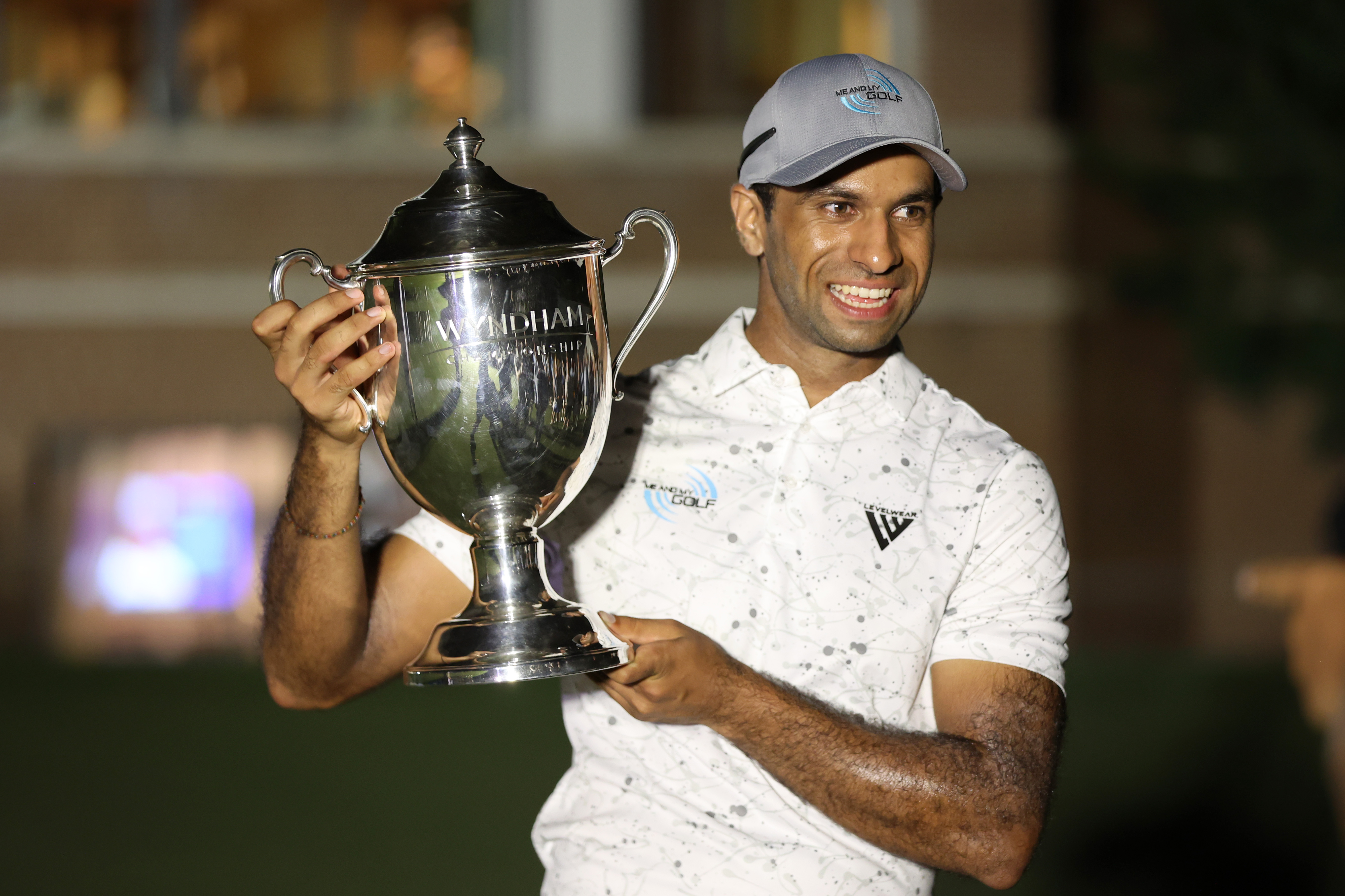 Aaron Rai holds the Wyndham Championship trophy