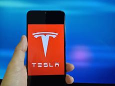 The Tesla logo on a smartphone