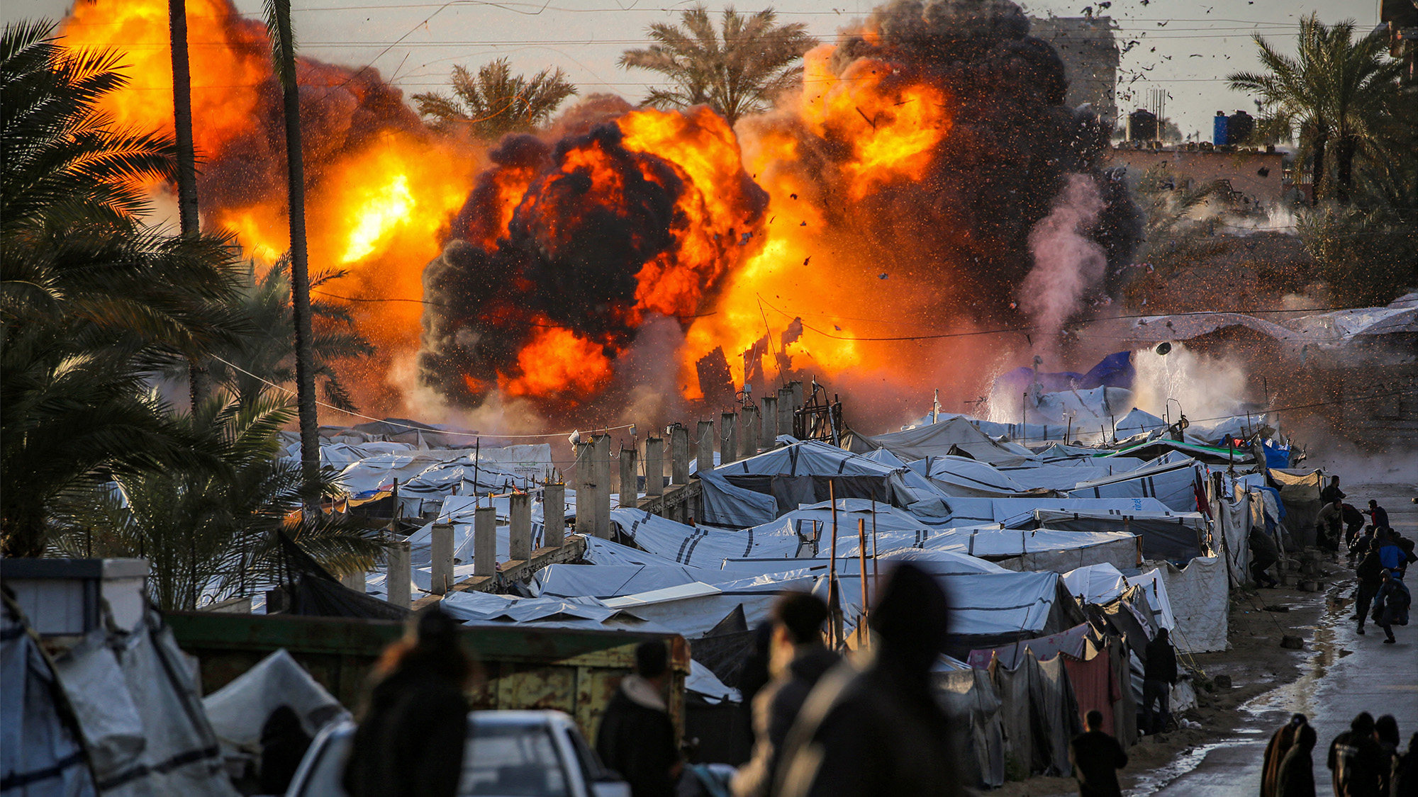 A fireball erupts following an Israeli strike on a tent encampment sheltering people displaced by war in Deir el-Balah, central Gaza Strip