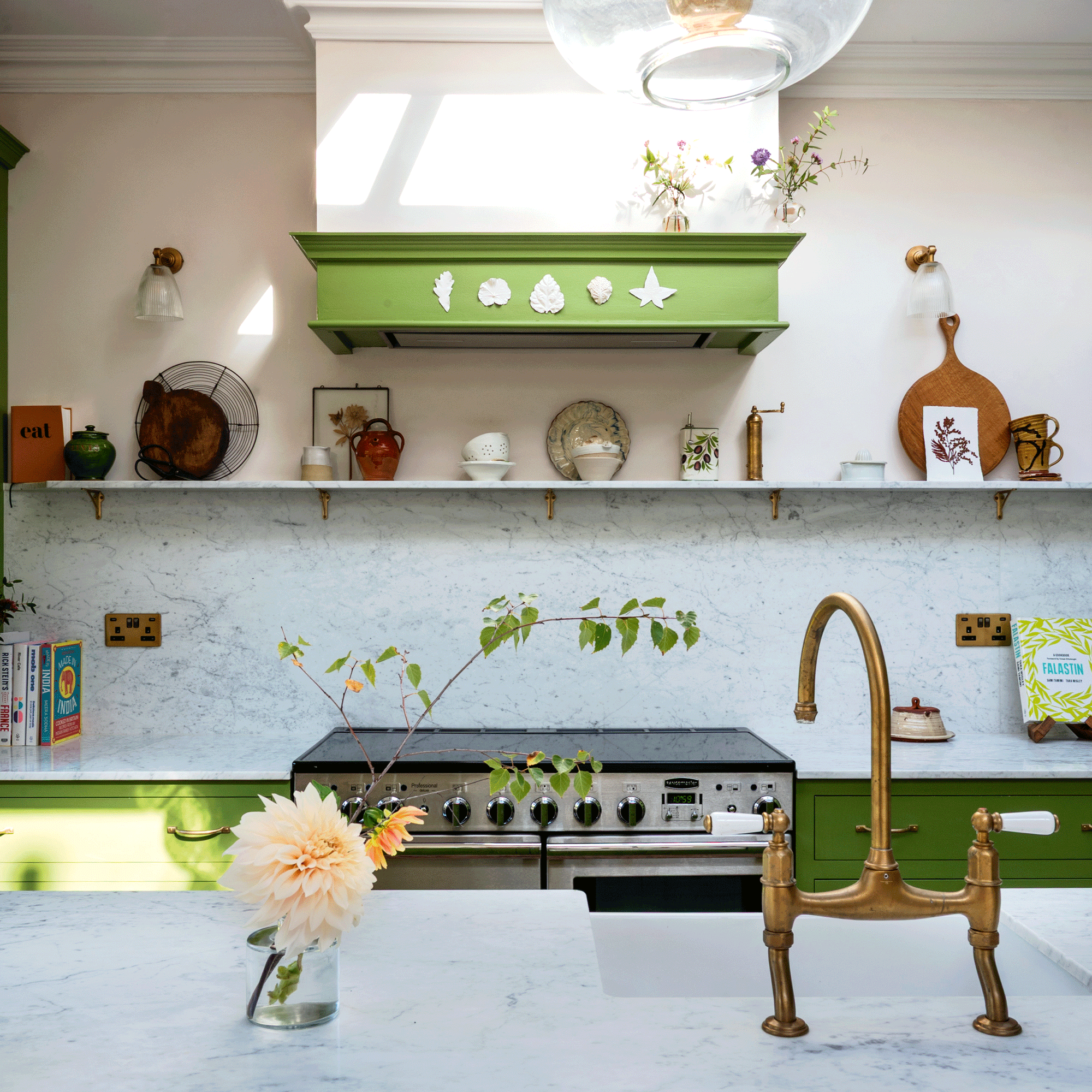 a green shaker kitchen with open shelving, a range cooker, and a large kitchen island