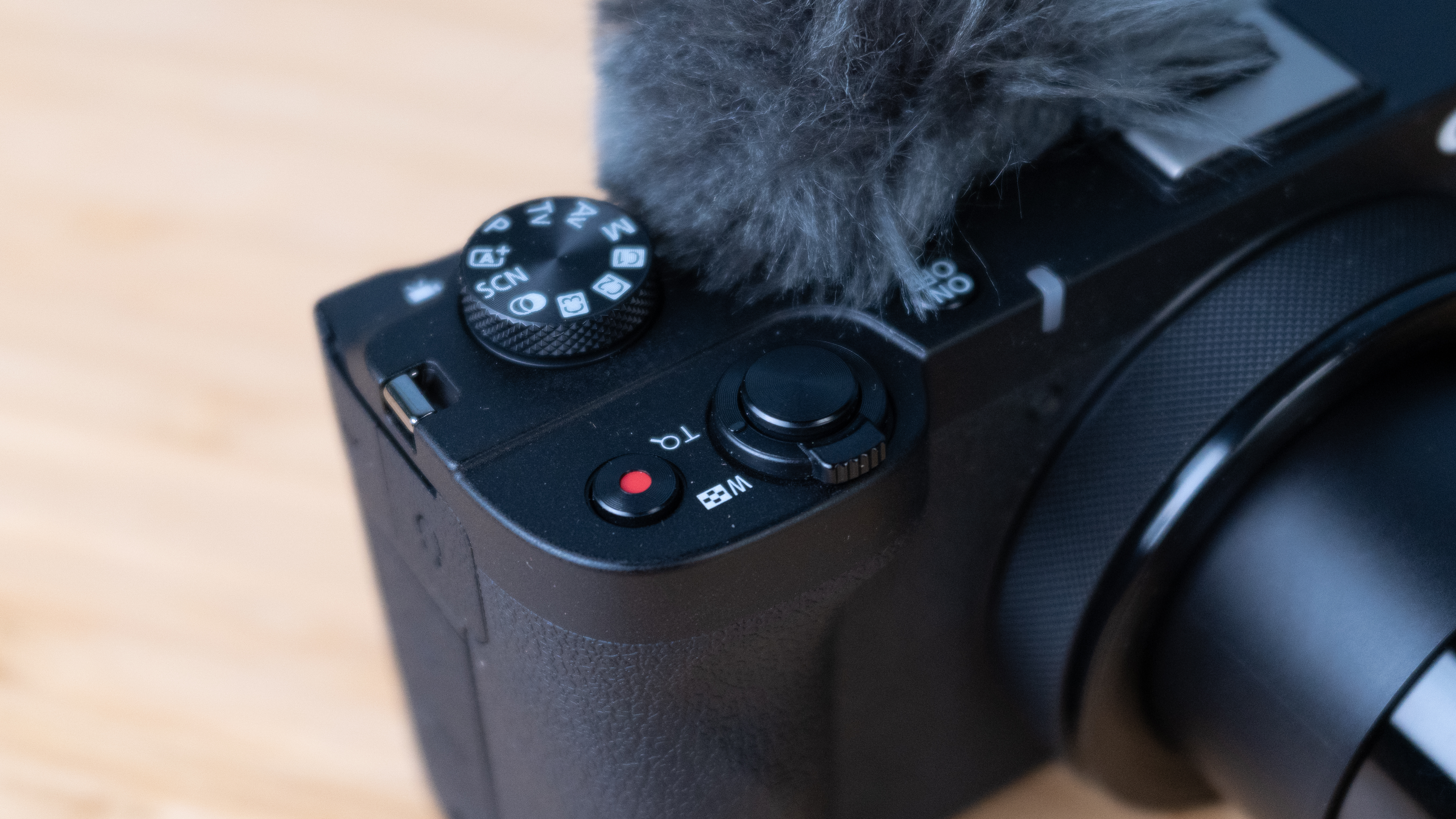 A black Canon PowerShot V1 compact vlogging camera