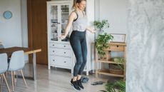 Woman skipping in domestic setting