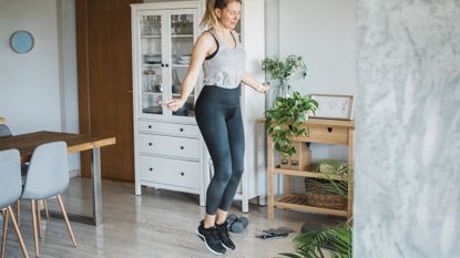 Woman skipping in domestic setting