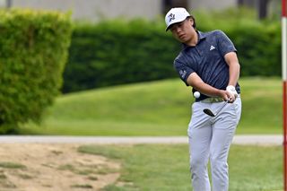 Jeffrey Guan strikes a chip shot onto the green