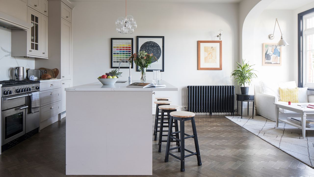 open plan kitchen living space with central island and cream units