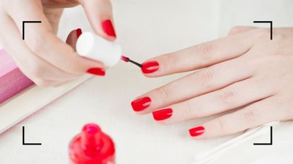 how to paint your nails main image of woman doing her own red manicure