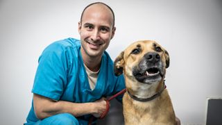Male vet with dog on World Veterinary Day