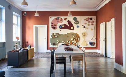 Long dining table in colourful room