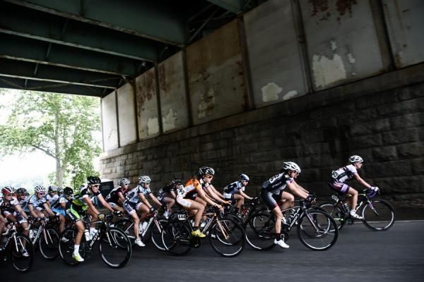The women traverse under an industrial bridge on the way to Manayunk.