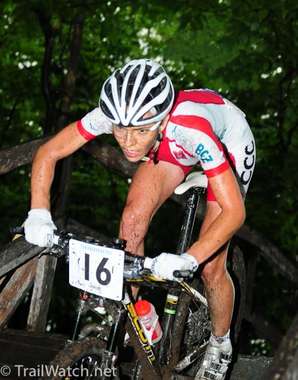 Maja Wloszczowska (Poland) crosses a wooden bridge with the lead