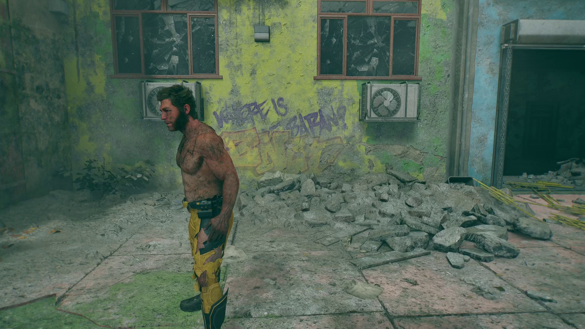 Wolverine standing infront of a wall with writing on it during Wolverine
