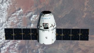 A SpaceX Dragon spacecraft above Earth.