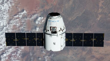 A SpaceX Dragon spacecraft above Earth. 