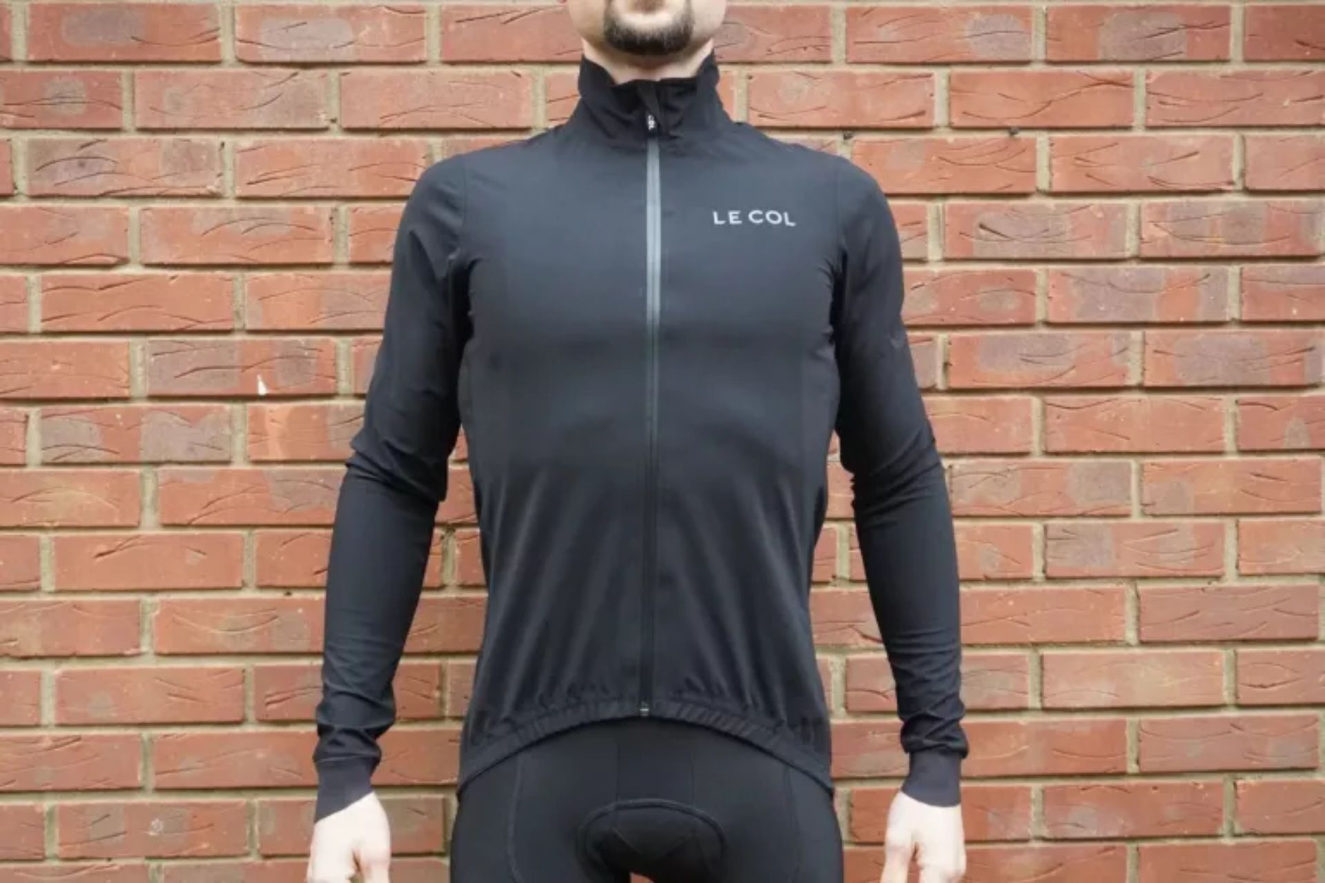 Image shows a rider wearing the Le Col Pro Rain Jacket.