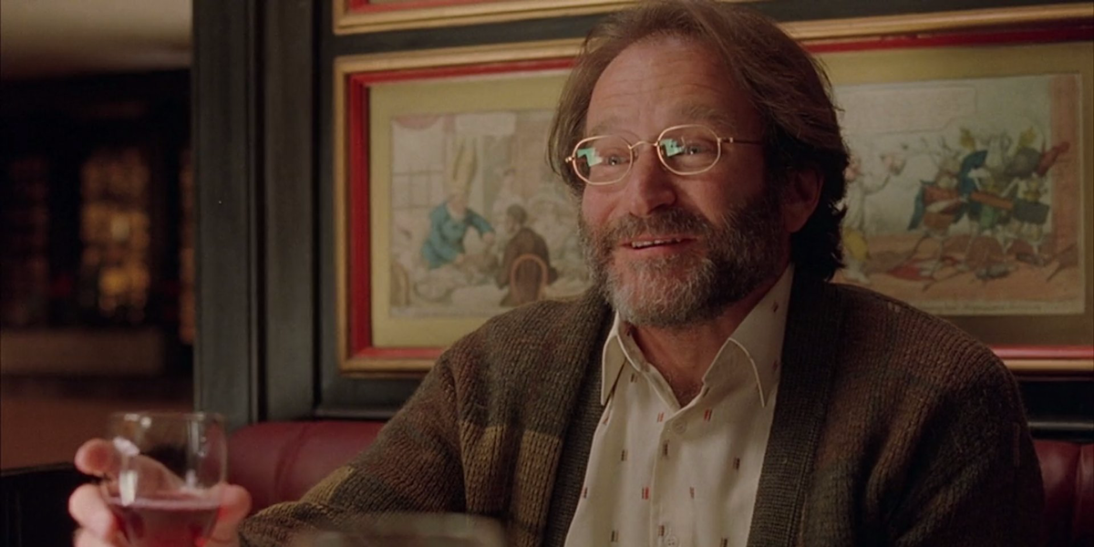 Sean Maguire (Robin Williams) sits at a restaurant holding a drink in a scene from &#039;Good Will Huntin