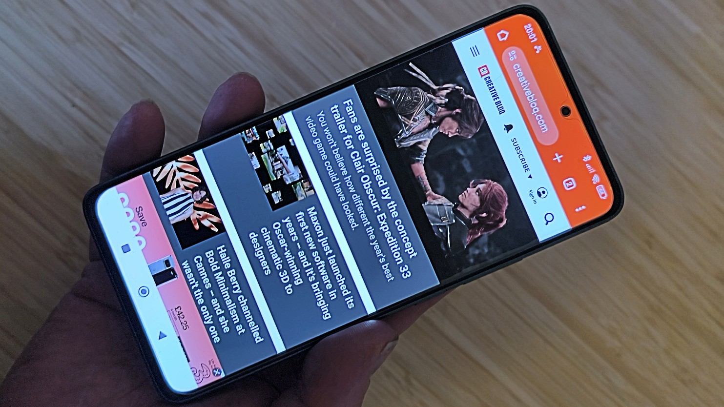 Poco M7 Pro in hand showing Creative Bloq on screen