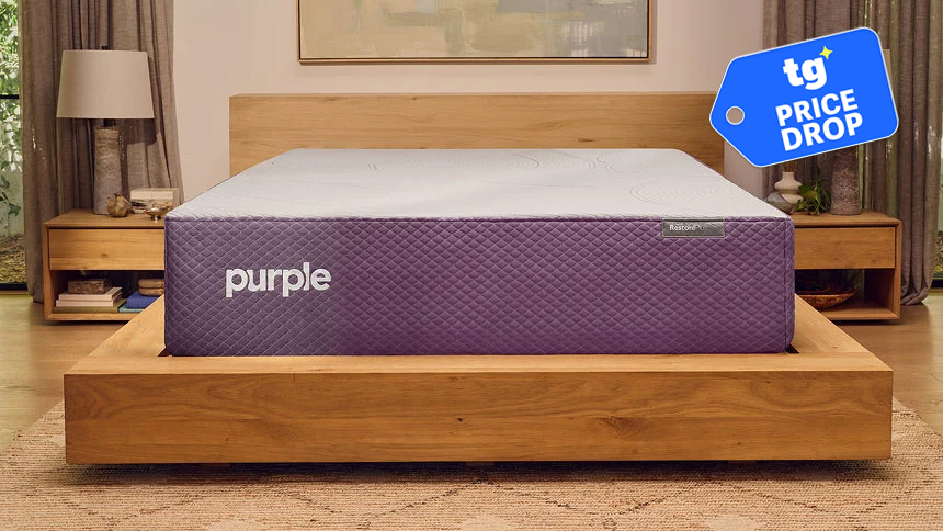 The Purple Restore Mattress on a wooden bed frame in a bedroom, a Tom's Guide price drop deals graphic in the top right corner