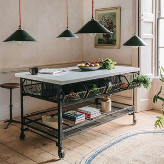 kitchen with freestanding kitchen island, pendant light, wooden floor, coir rug, stool, artwork